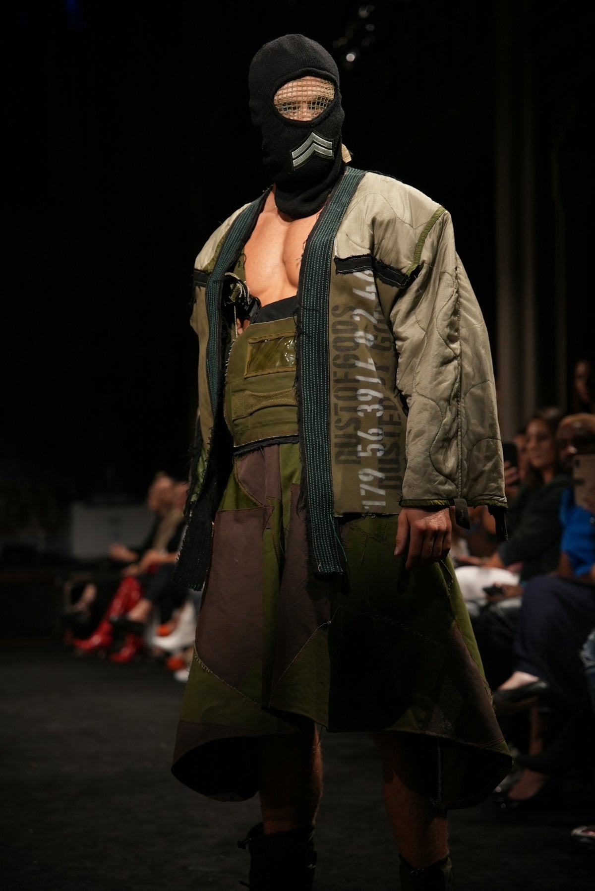 Fashion model wearing a balaclava and unique repurposed clothing